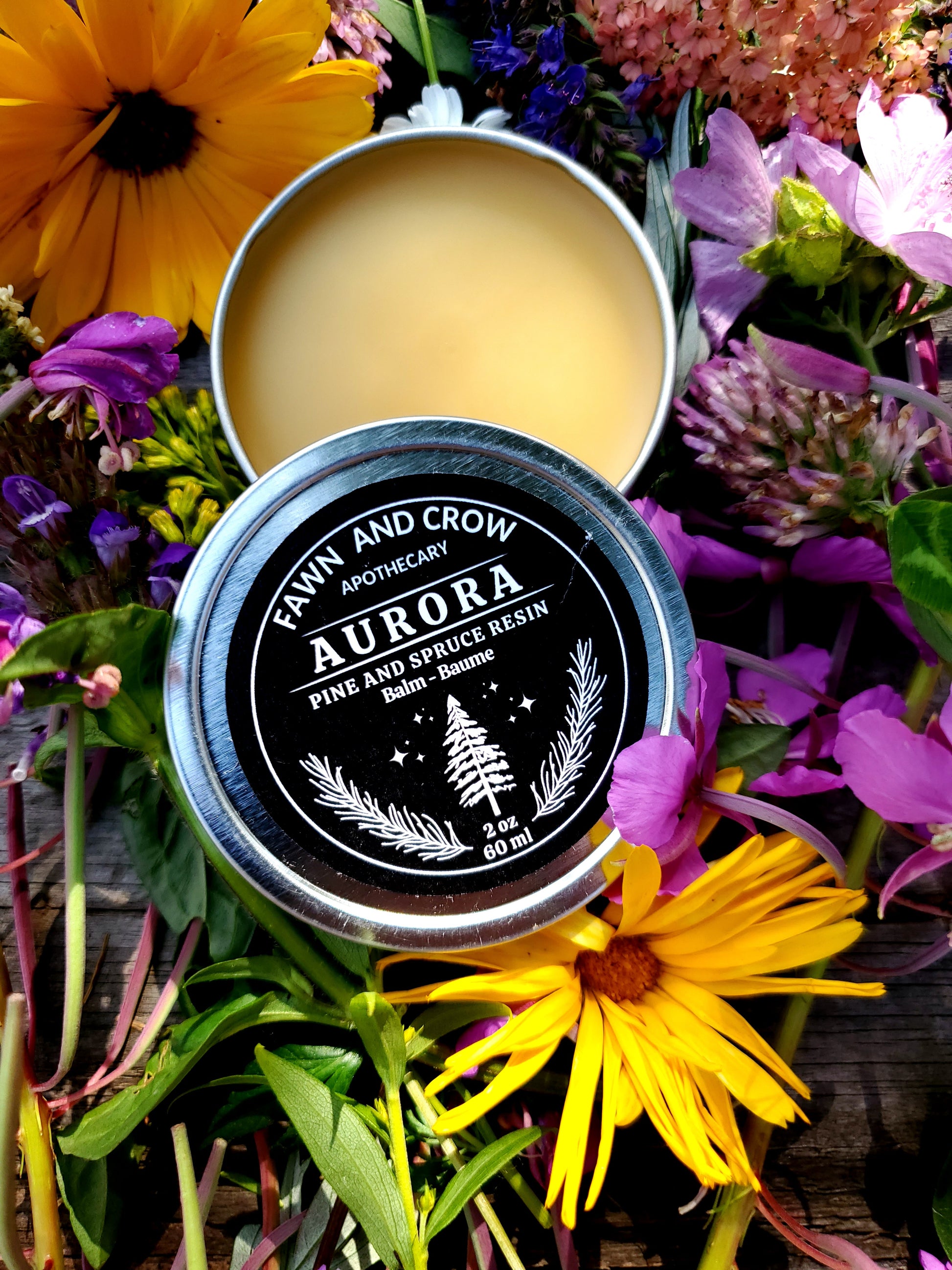 Fawn and Crow Apothecary Aurora balm container with floral background