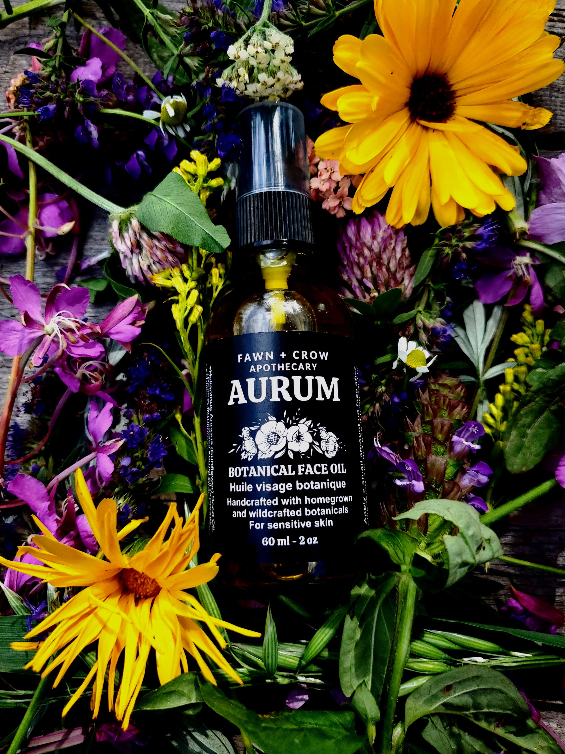 Aurum botanical face oil bottle surrounded by flowers and plants