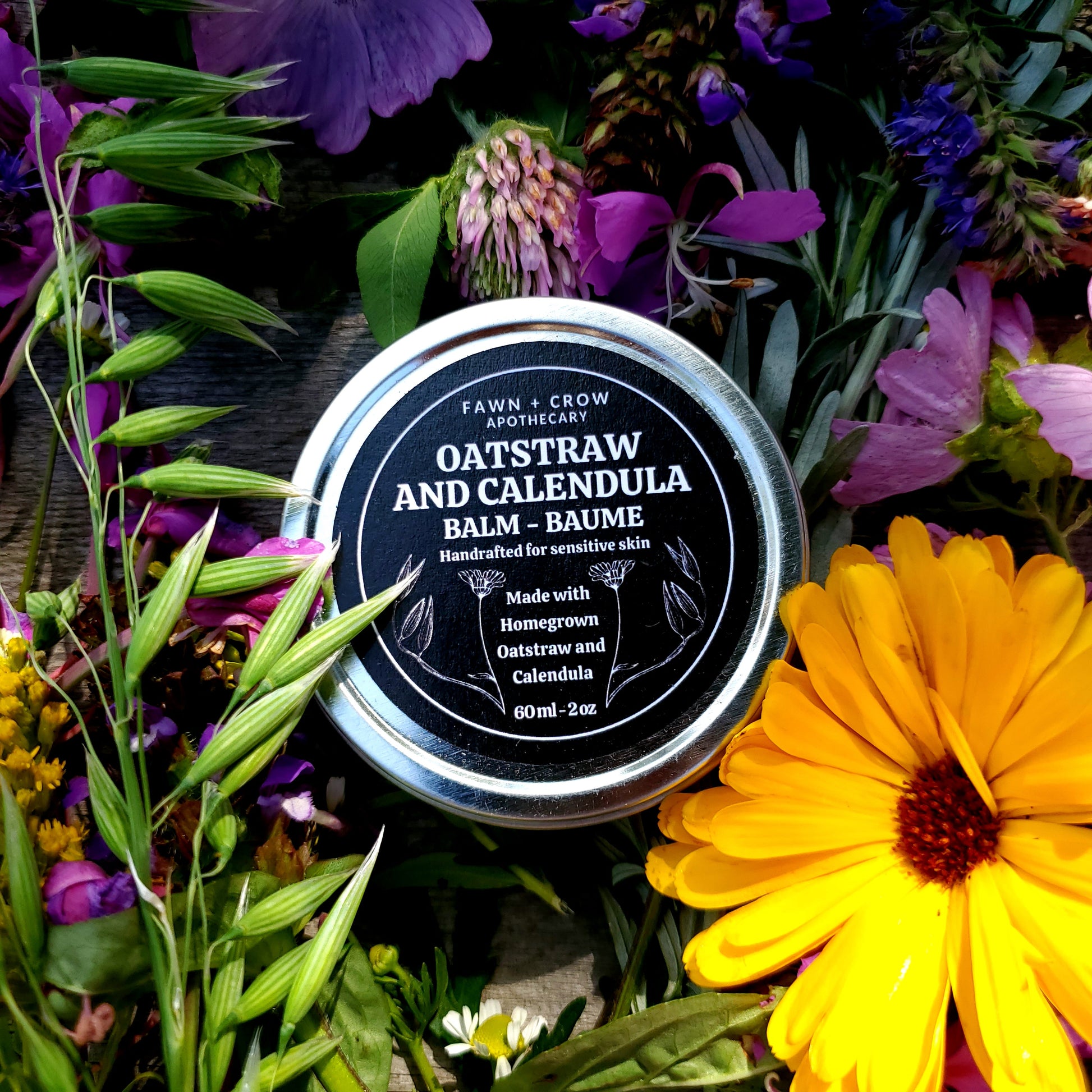 Balm container surrounded by flowers on a dark background