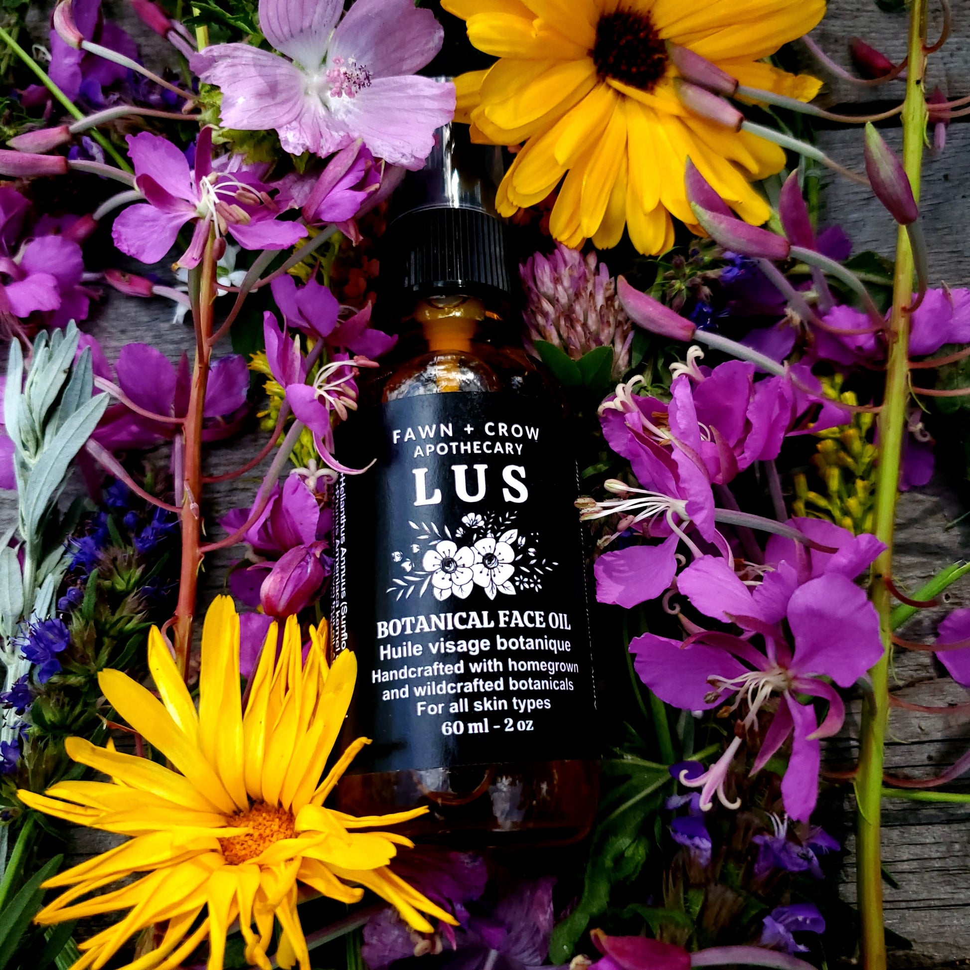 A bottle of Fawn and Crow botanical face oil surrounded by flowers