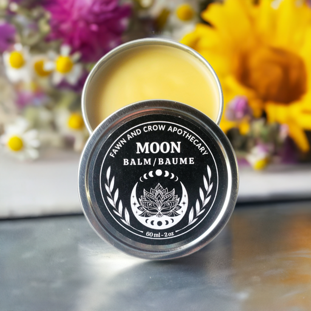 Menstrual cycle herbal balm in silver tin with flowers in back ground